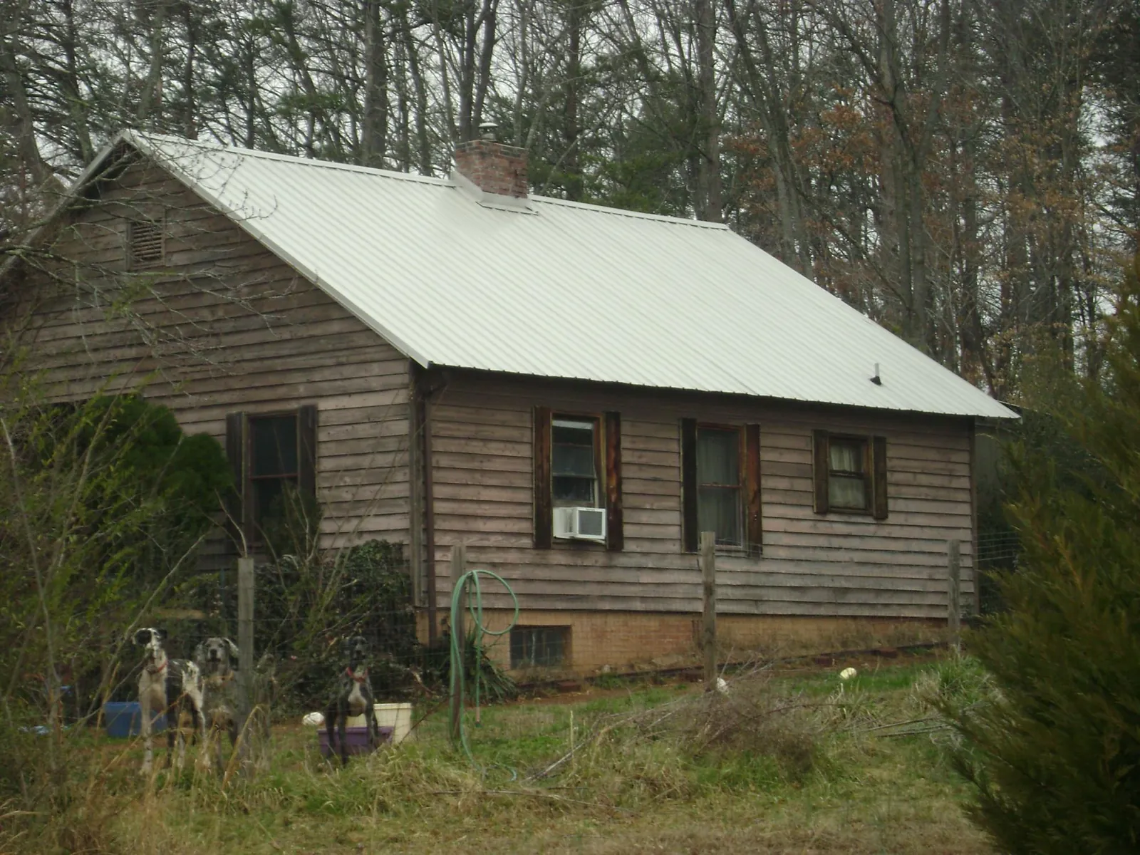 White metal roof on an old wood sided farmhouse, from a Asphalt Shingle Roof Repair job in Carbon